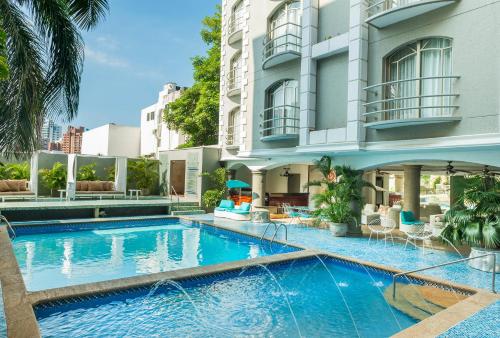 a swimming pool in front of a building at Country International Hotel in Barranquilla