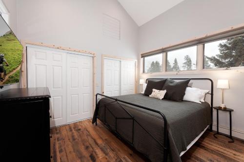a bedroom with a bed and two windows at 3076 W Highway 160 - Combo in Mancos