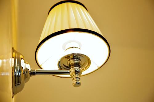 a light that is attached to a wall at Palazzo Papa Gregorio XVI in Tivoli