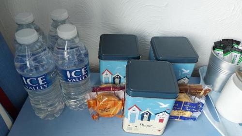 a table with bottles of water and houses on it at The Clifton at Paignton in Paignton