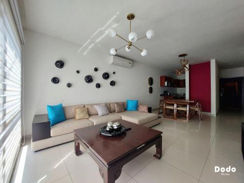 a living room with a couch and a table at Dodo Plaza Machado in Mazatlán