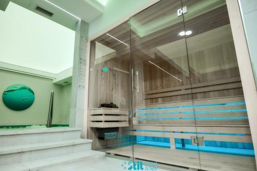 uma piscina num quarto com uma parede de vidro em Stil Motel & Spa em Tăşnad