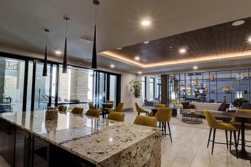 a lobby with a bar with yellow chairs and tables at Private Rooftop Terrance-Walk Score 81-Shopping District-King Bed-Parking 4021 in Scottsdale