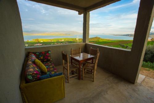 a balcony with a table and chairs and a view of the ocean at La Belle Etoile in Ouazzane