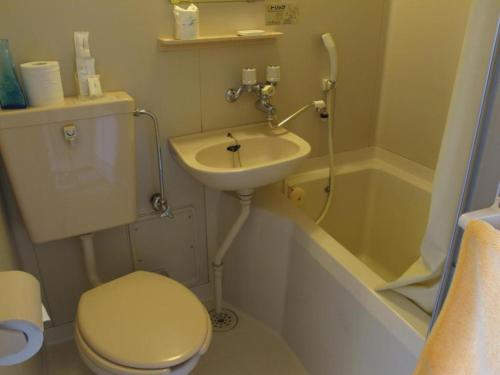 a bathroom with a sink and a toilet and a tub at Hotel Platon - Vacation STAY 62238v in Chikuma