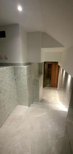 a room with a hallway with a tile floor at Boutique Hotel Acacia in Lovran