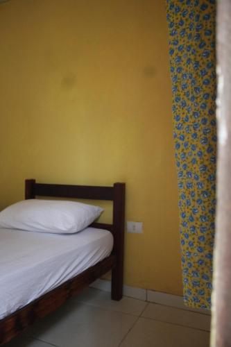 Postel nebo postele na pokoji v ubytování ROSÁRIO TEMPORADA Hostel