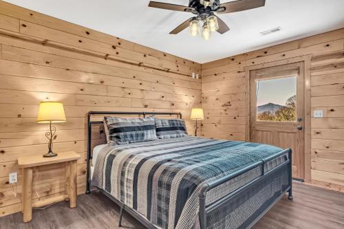 a bedroom with a bed and a ceiling fan at Paradise Found, Hot Tub, Mtn Views, Game Room, 560 FREE tickets each paid day! in Sevierville