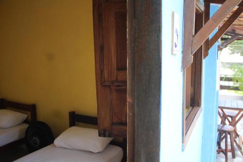 Postel nebo postele na pokoji v ubytování ROSÁRIO TEMPORADA Hostel