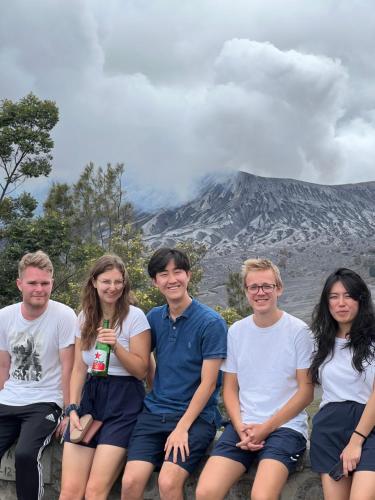 a group of people sitting in front of a mountain at Cahyo Homestay Bromo in Bromo
