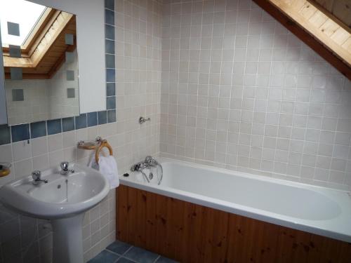 a bathroom with a bath tub and a sink at Waterville Holiday Homes No 10 in Waterville