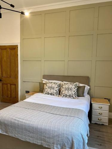 a bedroom with a bed with white sheets and pillows at Fayhomes West Midlands Luxury Late 1800 Property in Walsall