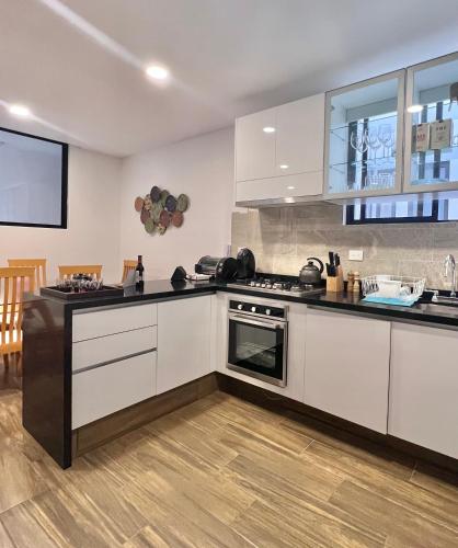 a kitchen with white cabinets and a stove at Departamento nuevo en el corazón de la Condesa in Mexico City