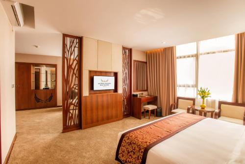 a hotel room with a bed and a television at Muong Thanh Grand Bac Giang Hotel in Bắc Giang