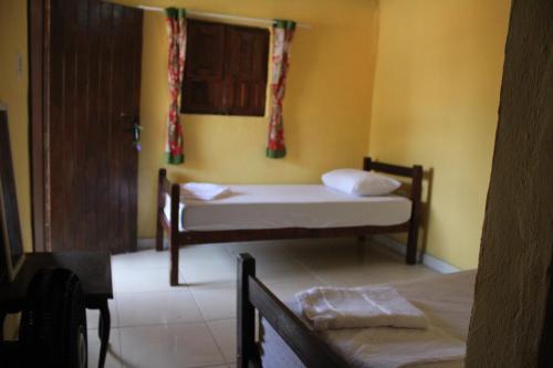Postel nebo postele na pokoji v ubytování ROSÁRIO TEMPORADA Hostel
