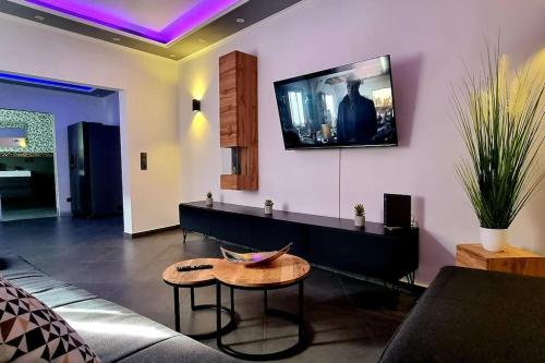 a living room with a couch and a tv on the wall at Luxus Loft Whirlpool Designer Küche Bad in Herdecke