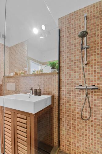 a bathroom with a sink and a shower at Asteri Garden & Terrace Apartment in Sinaia
