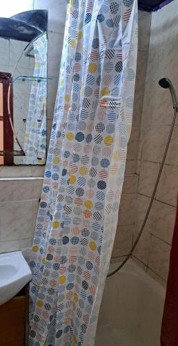 a shower curtain in a bathroom with a shower at Apartament Amurg in Dej