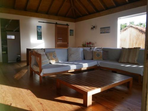 a living room with a couch and a coffee table at La Villa créole in Terre-de-Haut