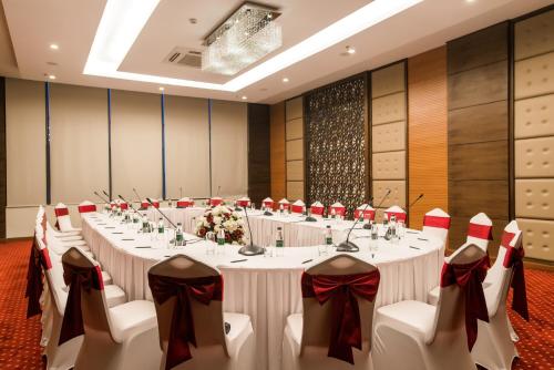 a large banquet hall with white tables and chairs at Muong Thanh Grand Bac Giang Hotel in Bắc Giang