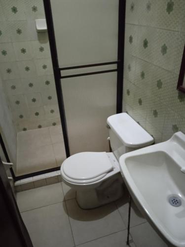 a bathroom with a toilet and a sink at Residencias MARGARITA in Manizales