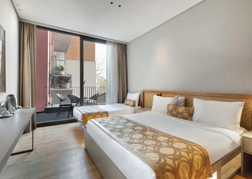 a hotel room with a large bed and a balcony at Galata Rasso Hotel in Istanbul