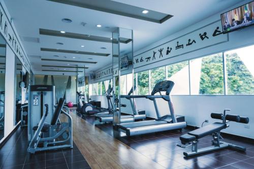 a gym with cardio equipment in a building at Riu Playacar - All Inclusive in Playa del Carmen