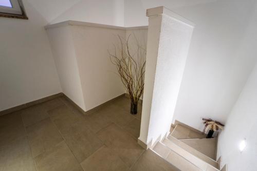 a hallway with a vase on the floor and a staircase at Villa Luka with private pool near Pula in Pula