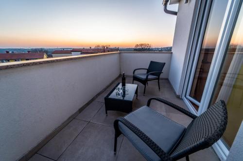 a balcony with two chairs and a table at Villa Luka with private pool near Pula in Pula