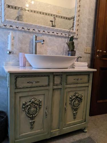 a bathroom vanity with a sink and a mirror at La Rosetta in Querceta