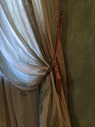 a curtain that is tied to a window at La Rosetta in Querceta