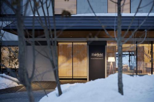 a building with glass doors in the snow at Fairfield by Marriott Okayama Hiruzen Highland in Maniwa