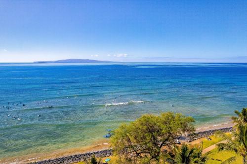 an aerial view of a beach with people in the water at Island Surf 601A in Kihei