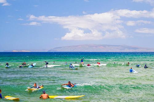a group of people in the ocean on surfboards at Island Surf 601A in Kihei
