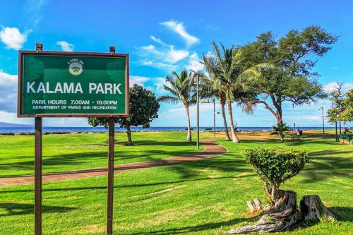 a sign for kalamaja park with palm trees in the background at Island Surf 601A in Kihei