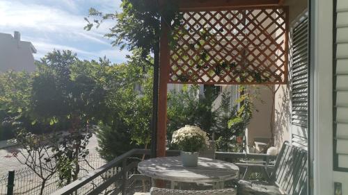a patio with a table and a gazebo at Cosy home Lalëz Durrës in Mullini i Danit