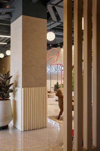 a lobby with columns and a sign in the background at Blues Suites Medellín in Medellín