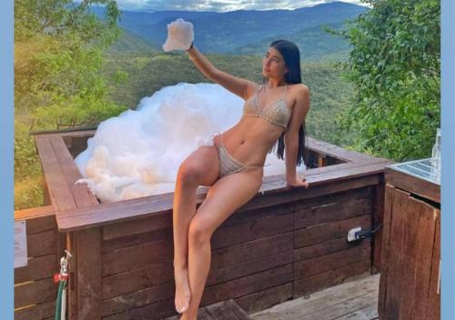 a woman in a bikini standing on top of a box at Chinauta_Eco_Glamping in Fusagasuga