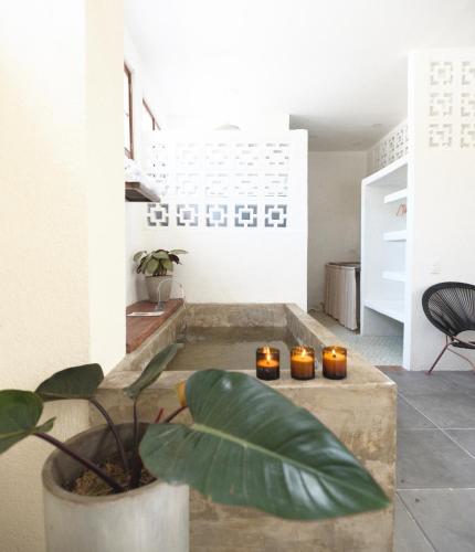 a living room with candles on a table with a plant at La Casa del Totumo in Santa Marta