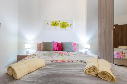 a bedroom with a large bed with two towels on it at H2 -Modern and Spacious 3 Bedroom Apartment in San Ġwann