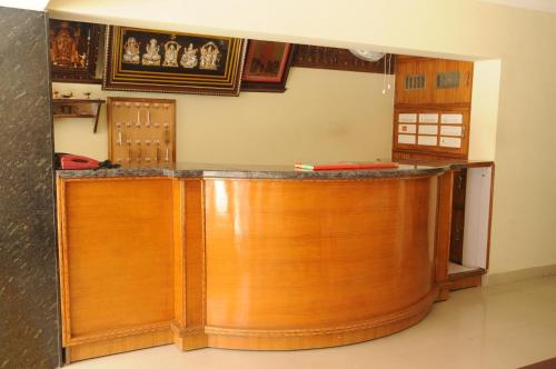 uma cozinha com um balcão de madeira num quarto em Hotel Agarala Residency em Tirupati