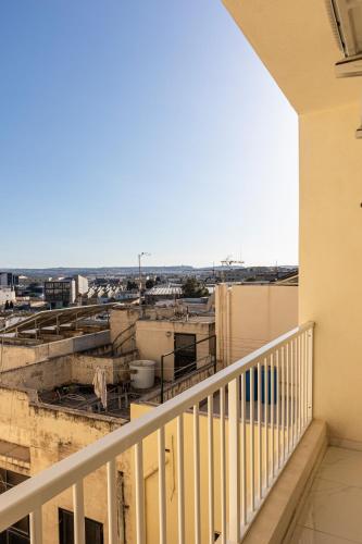 a balcony with a view of a city at H2 -Modern and Spacious 3 Bedroom Apartment in San Ġwann