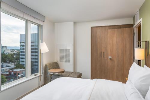 a bedroom with a bed and a large window at Element Denver Downtown East in Denver