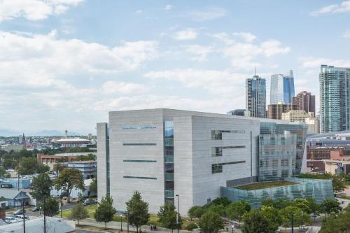 a large white building with a city in the background at Element Denver Downtown East in Denver