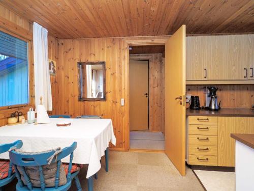 a kitchen with a table and chairs in a room at 5 person holiday home in Føllenslev-By Traum in Føllenslev