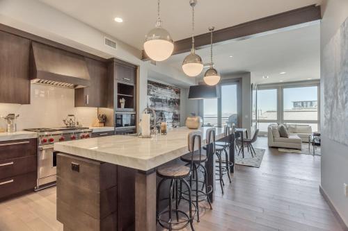 a kitchen with a large island with bar stools at Stein Eriksen Residences in Park City