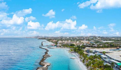 an aerial view of a beach with buildings and the ocean at Elisabeth Residence Mambo Beach in Dominguito