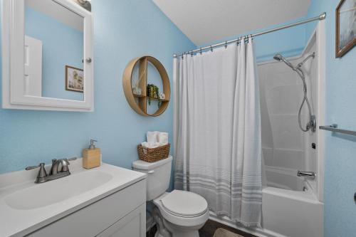 ein Badezimmer mit einem weißen WC und einer Dusche in der Unterkunft Beach Twin B KDH123B in Kill Devil Hills