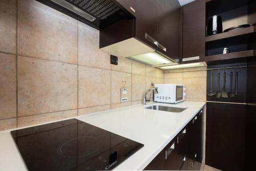 a kitchen with a sink and a microwave at Tennis apartment Dubrovnik, FREE parking, beach in Dubrovnik