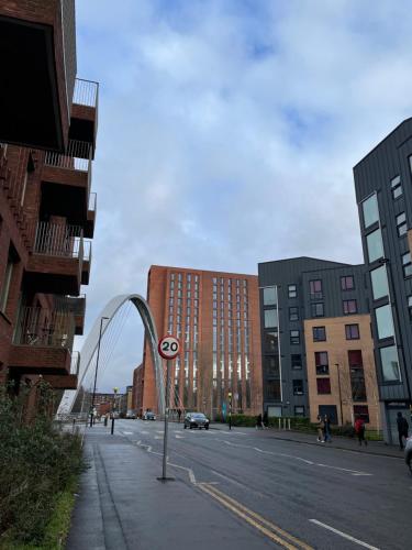 a view of a street with buildings and a street sign at Entire house with parking in Manchester